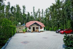 a house with a parking lot in front of it at Hazel Retreat - Full Home & Coffee Estate in Chikmagalūr