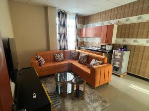 a living room with a couch and a table at Mima's Apartment in Dar es Salaam