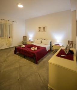 a bedroom with a bed and two chairs and a table at La Casa di Antonella in Agrigento
