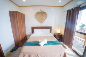 a bedroom with a bed with a heart on it at Kasagpan in Tagbilaran City