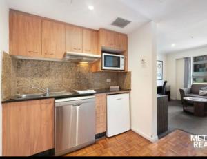 a kitchen with a sink and a microwave at Darling Harbour in Sydney