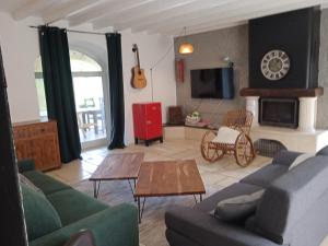 ein Wohnzimmer mit einem Sofa und einem Tisch in der Unterkunft le Domaine des Sauvineries in Saint-Germain-de-Prinçay