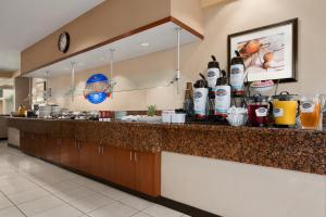 a kitchen with a counter with drinks on it at Baymont by Wyndham Columbia Northwest in Columbia