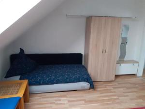 - une chambre avec un lit et une armoire en bois dans l'établissement Casa Mia Russotto 4, à Bruchköbel