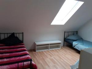 a bedroom with two beds and a skylight at Casa Mia Russotto in Bruchköbel +4 photos