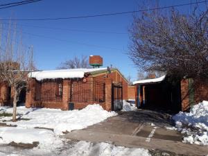 a brick building with snow in front of it at Casa Santa Elena in Malargüe