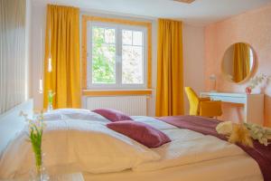 - une chambre avec un grand lit et une fenêtre dans l'établissement Wellnessoase mitten in Triberg, à Triberg