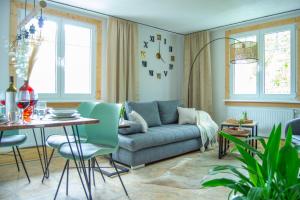 a living room with a couch and a table at Wellnessoase mitten in Triberg in Triberg