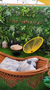 a exhibit with a hammock in front of a garden at Good Atmosphere Apartment in El Vendrell