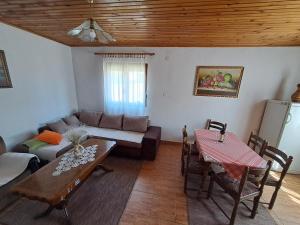 a living room with a couch and a table at Vikendica Borje in Žabljak +42 photos