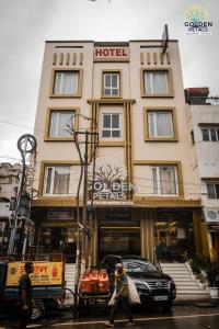 a hotel with a car parked in front of it at Hotel Golden Petals in Varanasi
