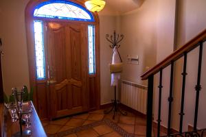 a hallway with a wooden door and a window at Casa de la Torre in Granada
