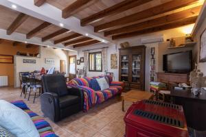 a living room with a couch and a tv at Finca Sa Sort 454 in Inca