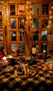 a table with plates of food and a bottle of wine at Sheriff, Olympos in Kumluca