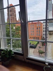 a view of a city from a window at Art Apartment Długa in Gdańsk
