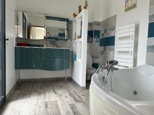 a bathroom with a tub and a sink and a toilet at le petit versaille in Saint-Paul-Trois-Châteaux