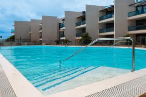 a swimming pool in front of a building at Casa Lilia in El Cotillo