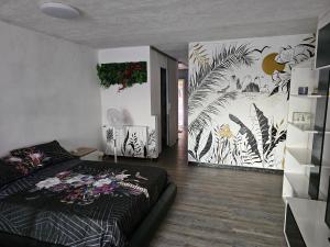 a bedroom with a bed and plants on the walls at Estudio en alquiler in Begur