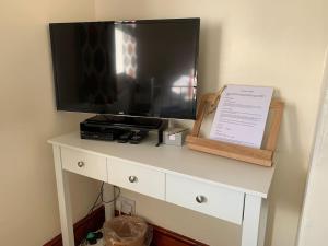 a tv sitting on top of a white dresser at Self Contained Guest Suite in South Milford