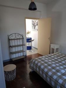 a bedroom with a bed and a table and a door at F1 centre ville in Bohain-en-Vermandois