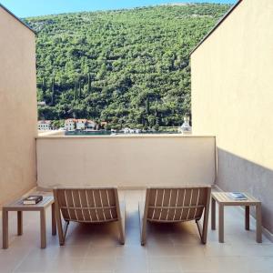 a table and two chairs on a balcony with a view at Studio More Amore Dubrovnik in Dubrovnik