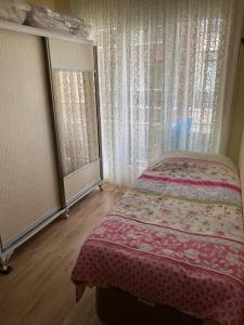 a bedroom with a bed and two large windows at Prestij beykent rezidance in Buyukcekmece