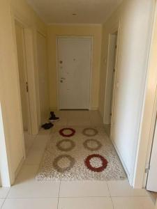 a hallway with a rug on the floor of a room at Prestij beykent rezidance in Buyukcekmece