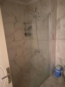 a shower with a glass door in a bathroom at Prestij beykent rezidance in Buyukcekmece