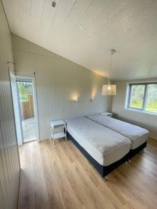 a bedroom with a large bed and a table at Stunning house - amazing scenery in Hvolsvöllur