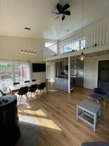 a large living room with a table and chairs at Stunning house - amazing scenery in Hvolsvöllur