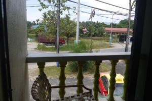 a window with a view of a street at ANZ LANGKAWI INN in Pantai Cenang