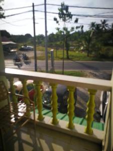 a balcony with a view of a parking lot at ANZ LANGKAWI INN in Pantai Cenang