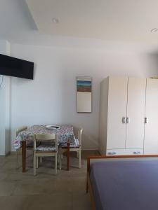 a room with a table and chairs and a cabinet at Bordoriva in Formia +27 photos