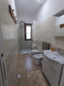 uma casa de banho com um WC, um lavatório e um chuveiro em Bordoriva em Formia