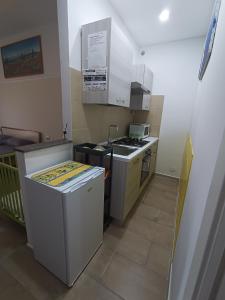 a small kitchen with a sink and a stove at Bordoriva in Formia