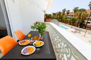 a table with breakfast food on top of a balcony at Apartment in Playa de las Americas in Playa de las Americas