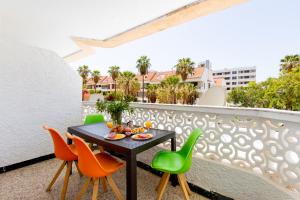 a balcony with a table and chairs on it at Apartment in Playa de las Americas in Playa de las Americas