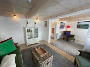 a living room with a couch and a chair at Teestuuv in Husum