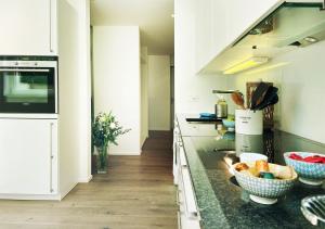 a kitchen with a counter with bowls of fruit on it at Stay at Night - Moonlight in Zürich