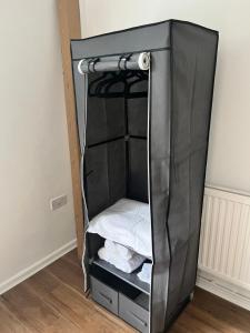a black bunk bed with white sheets in a room at Brand new cosy studio apartment in West Dulwich