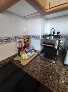 a kitchen with a counter top with a stove at Apartamento Tamarisco in Foz