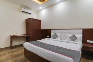 a bedroom with a large bed in a room at Townhouse Hotel Trijal Inn in Lucknow