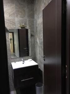 a bathroom with a sink and a mirror at TRIPLEX L'OCÉAN in Safi