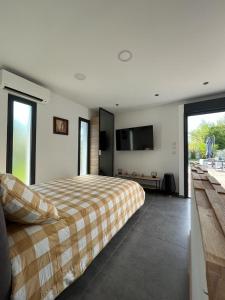 a bedroom with a bed and a flat screen tv at Le Minamo Studio in Six-Fours-les-Plages