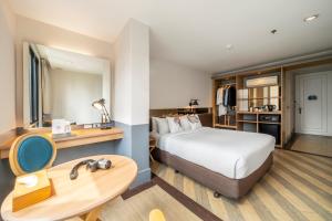 バンコクにあるVince Hotel Pratunamのベッドとバスルーム付きのホテルルームです。