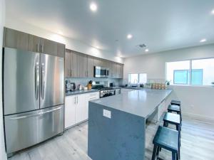 a large kitchen with a stainless steel refrigerator at Stylish 3 BR/3BR family house in Los Angeles