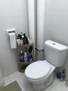 a bathroom with a white toilet and a pipe at M1 Budget Comfortable Central in Kuching