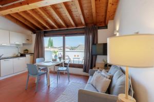 a living room with a couch and a table at Charming Sirmione in Sirmione