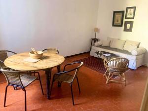 a living room with a table and chairs and a couch at La Demeure du Pont Vieux in Collobrières +15 photos