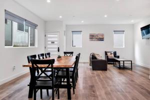 a dining room and living room with a table and chairs at Hollywood 3BR home near metro in Los Angeles